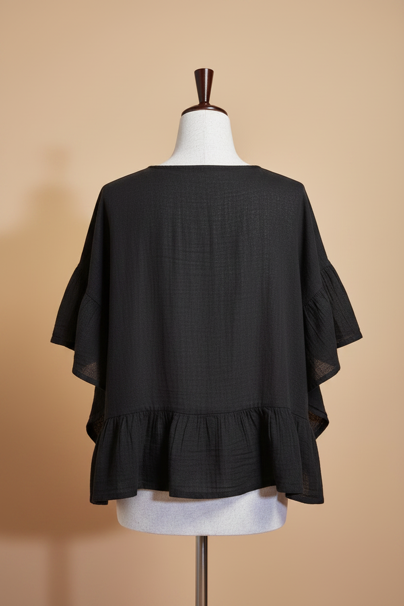 Blusa negra espalda fondo beige